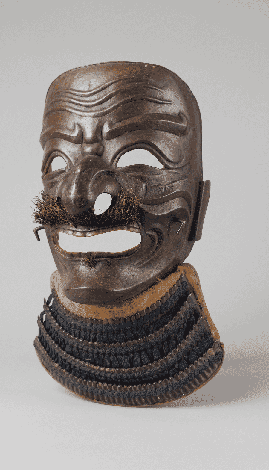 Three-quarter view of the Myochin iron somen and laced neck defence