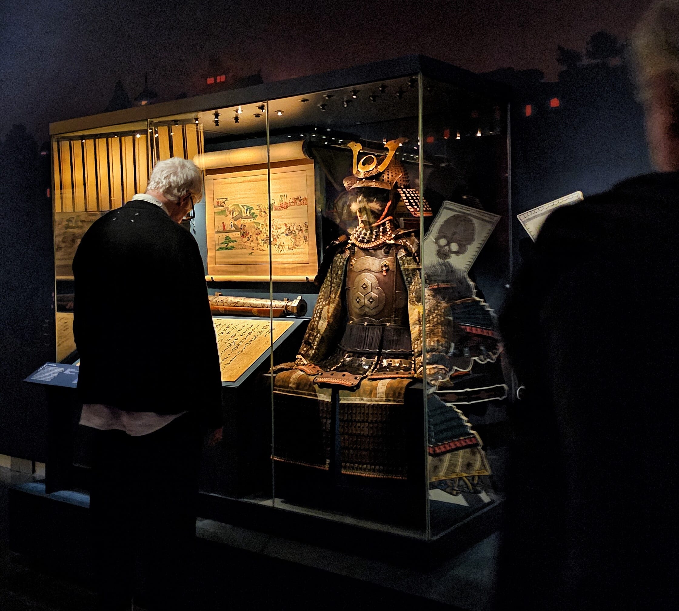 Visitor viewing a Kaga province samurai armour displayed in the exhibition gallery