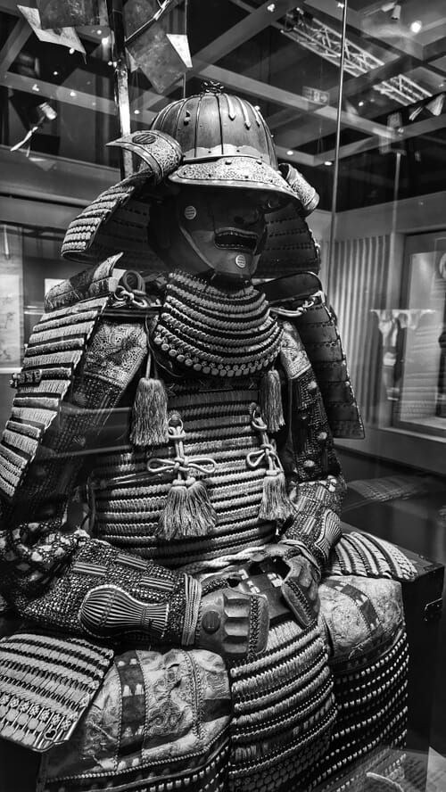 Samurai armour displaying multiple family crests on the dō and fitted with side mounted sashimono