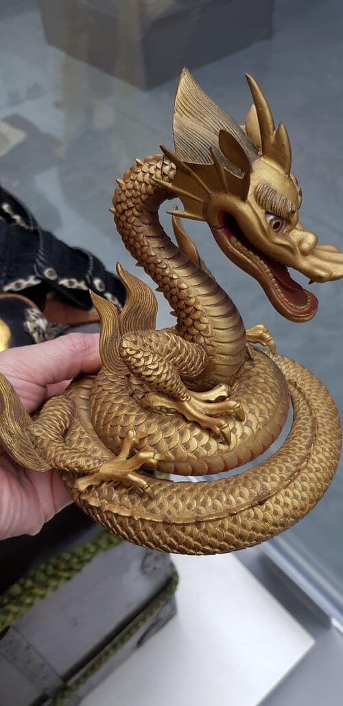 Close up of a carved dragon kashira-date on a Japanese kabuto helmet